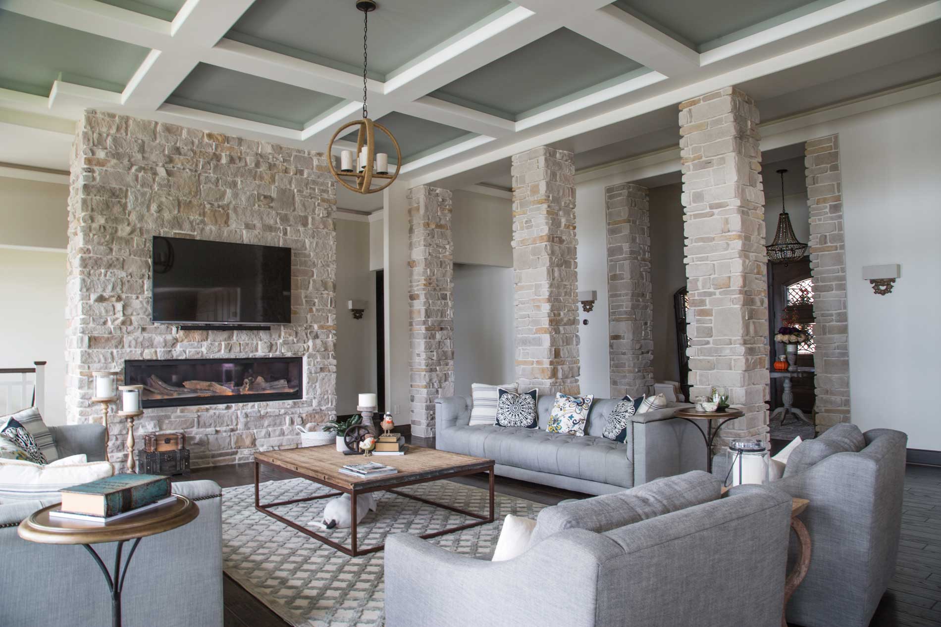 A living room featuring a fireplace and columns made with Bianco Blend