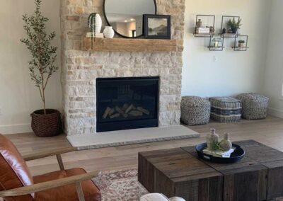A living room with a Bianco Blend fireplace.