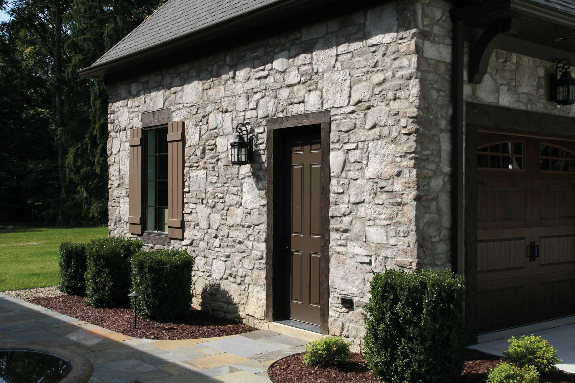 Casa-Matera-Country-Rubble-garage-window-door-dark-brown-trim