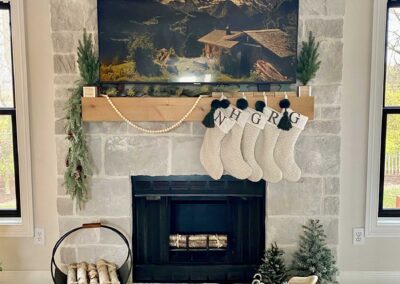 Casa di Sassi Niveo Volterra fireplace with a wooden mantel decorated for the holidays