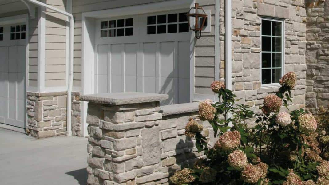 Light Colored house with stone wall caps