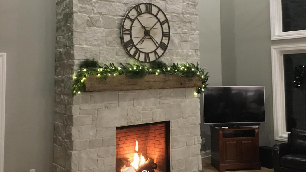Casa di Sassi stone veneer fireplace decorated for the holidays.