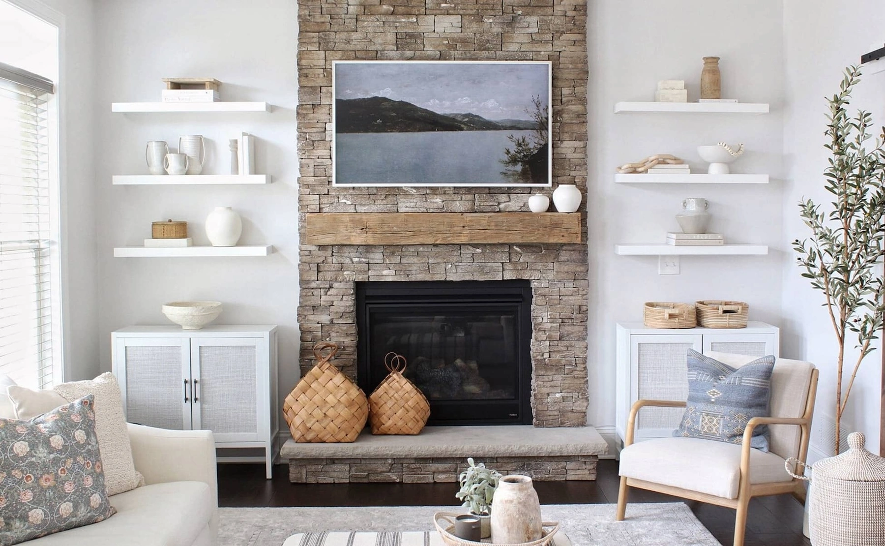 Tan and gray bricks around a minimalistic fireplace in a white living room.
