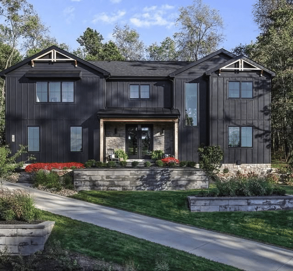 Curbside photo of a home with nice landscaping and stone retaining walls
