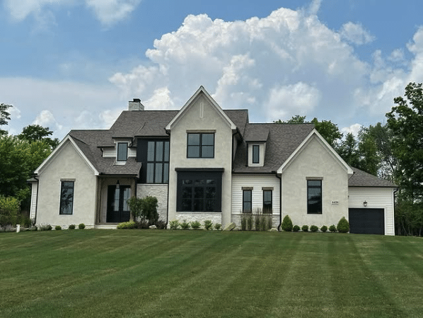 Curbside photo of home with stone walls
